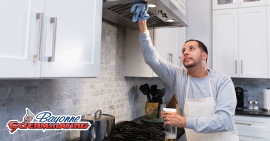 man in kitchen cleaning